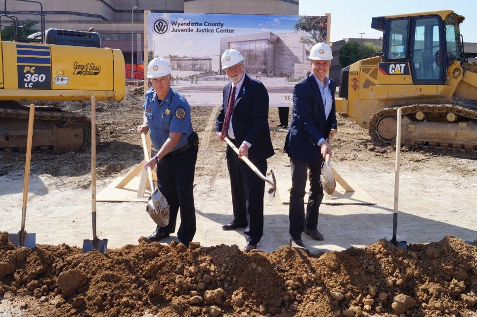 groundbreaking of juvenile justice center construction site with team members holding shovels